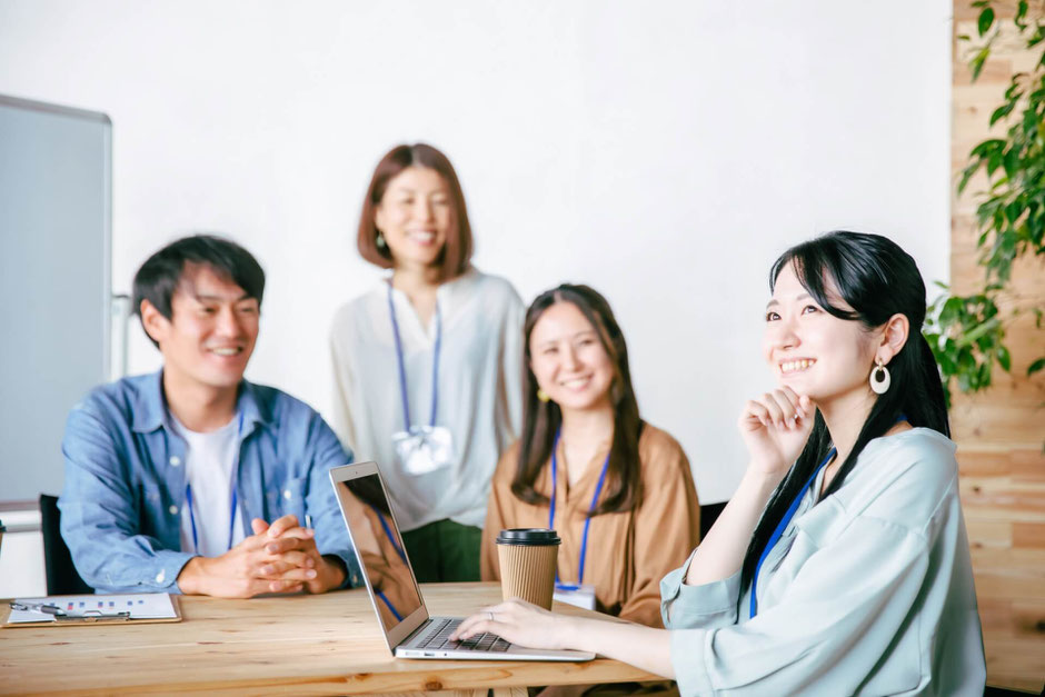 職場で笑顔で話す女性