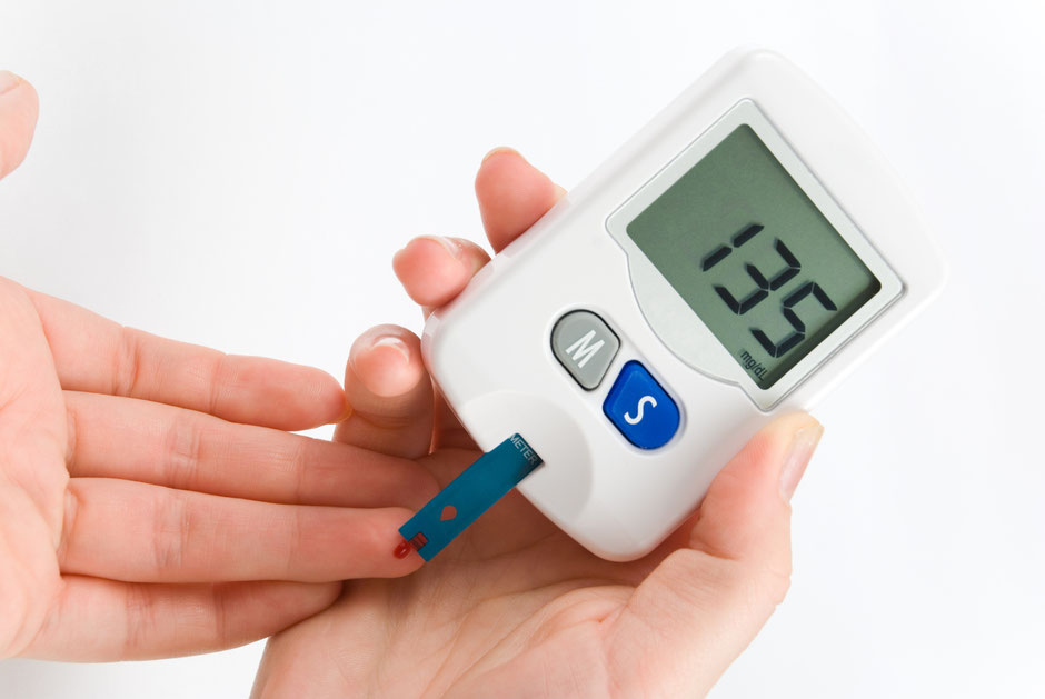 A picture of someone pricking their finger to check for blood sugar levels with the insulin device