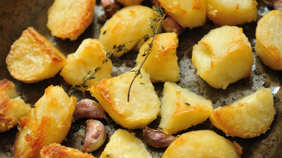 roasted potatoes and garlic on a baking tray