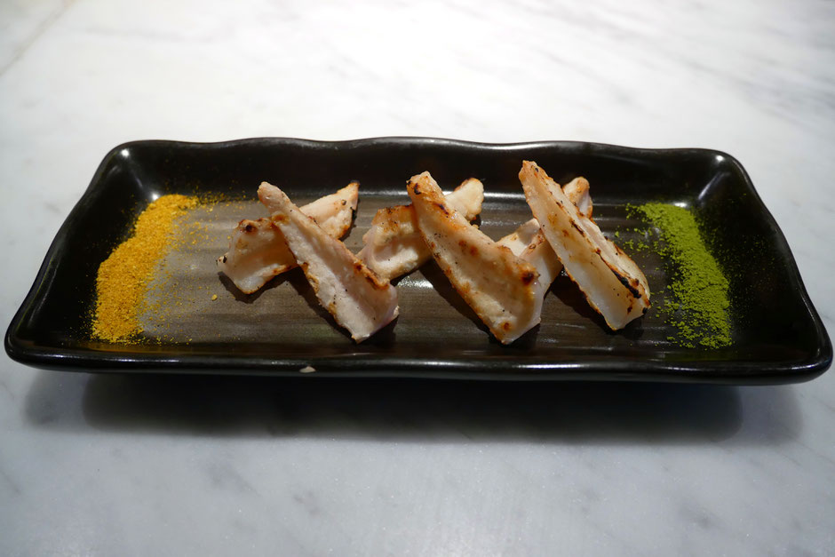 6 chicken breast bone cartilage served on a black porcelain plate with matcha and curry salt at Bincho Yakitori Singapore