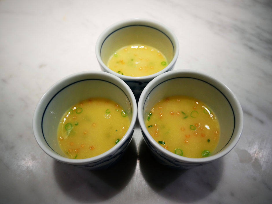 Three bowls of creamy chicken broth served in small white porcelain bowls at bincho yakitori singapore