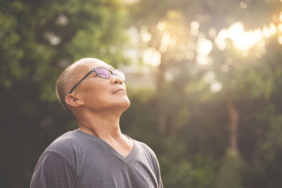 A healthy old man taking a deep breath of fresh air 