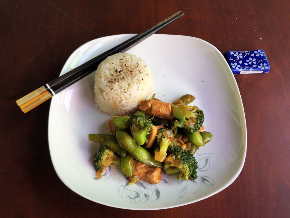 Plate of Chinese chicken and vegetable stir-fry served with activated brown rice