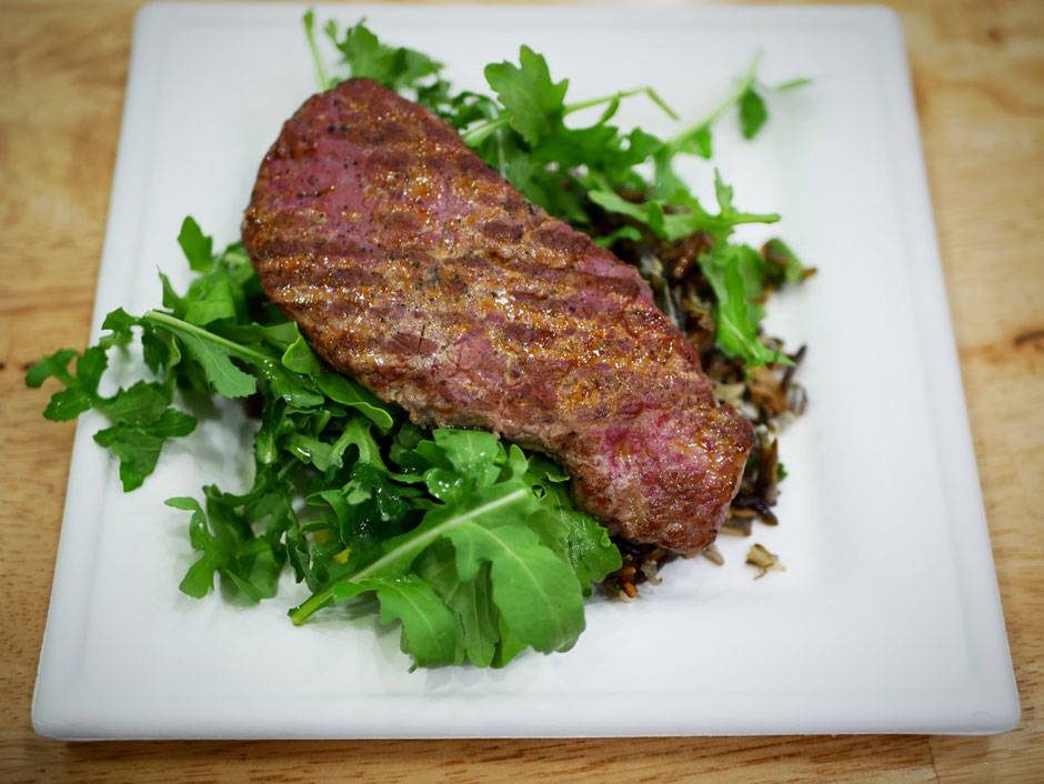 Wild rice salad with broccolini, mushrooms, arugula, and a lean strip steak at SuperNature Cafe