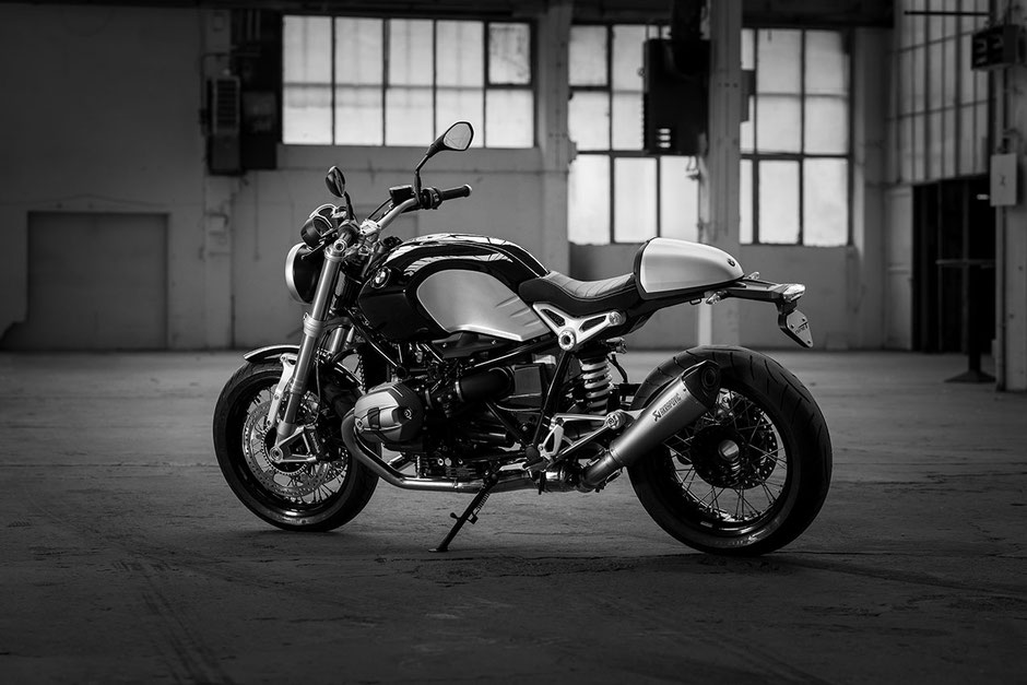 Black and white photo of the BMW R nine T motorcycle from the year 2024 in a big hall