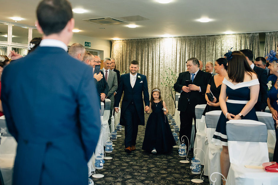 flower girl and page boy walking down the ailse at ribby hall as guests look
