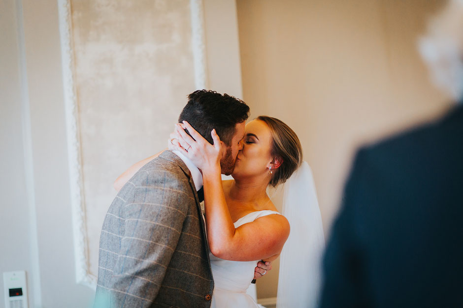 bride and groom having their first kiss during their wedding ceremony