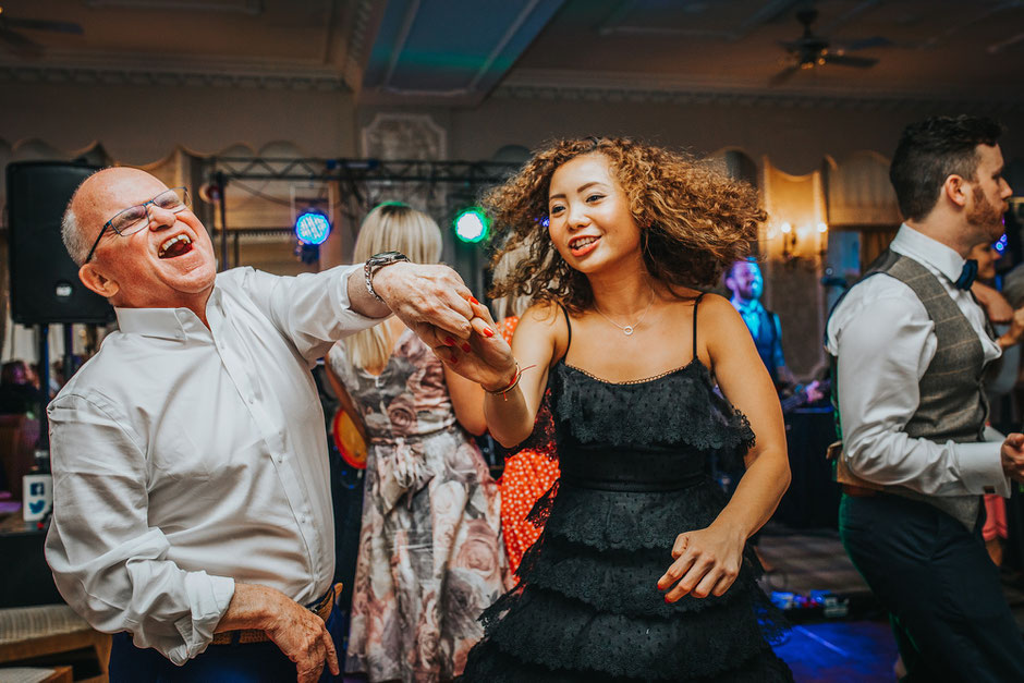 man and lady dancing at a wedding whilst holding hands