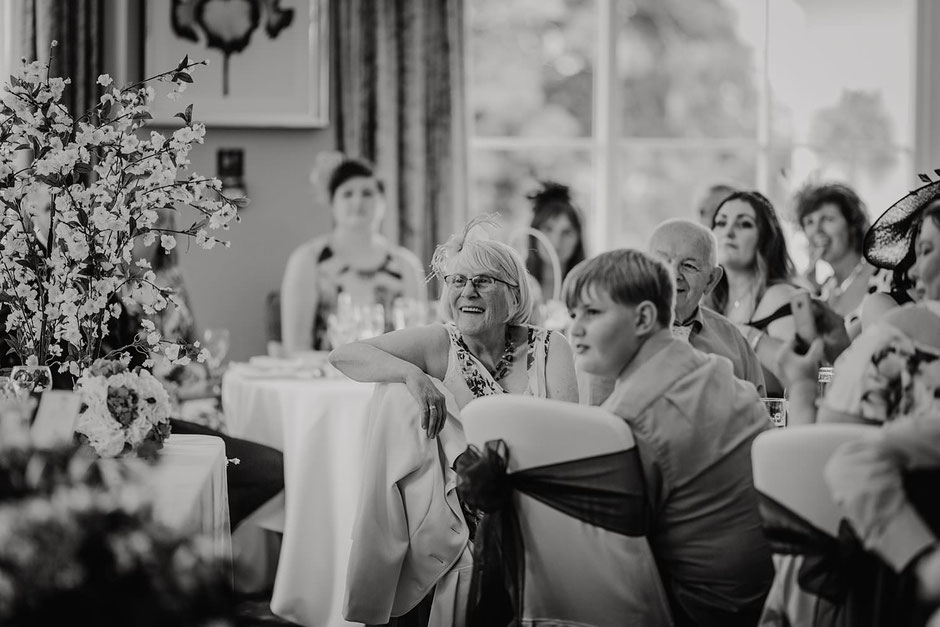 candid photograph of guests watching wedding speeches