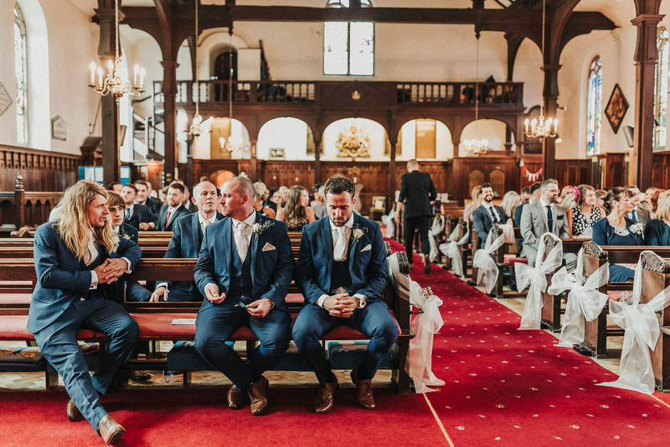 a very anxious looking groom waiting in church