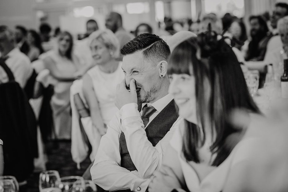 a black and white photograph of a man cringing during speeches