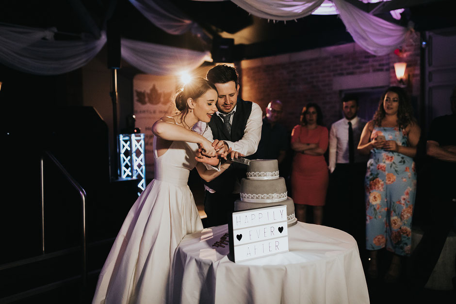 bride and groom cutting their grey wedding cake