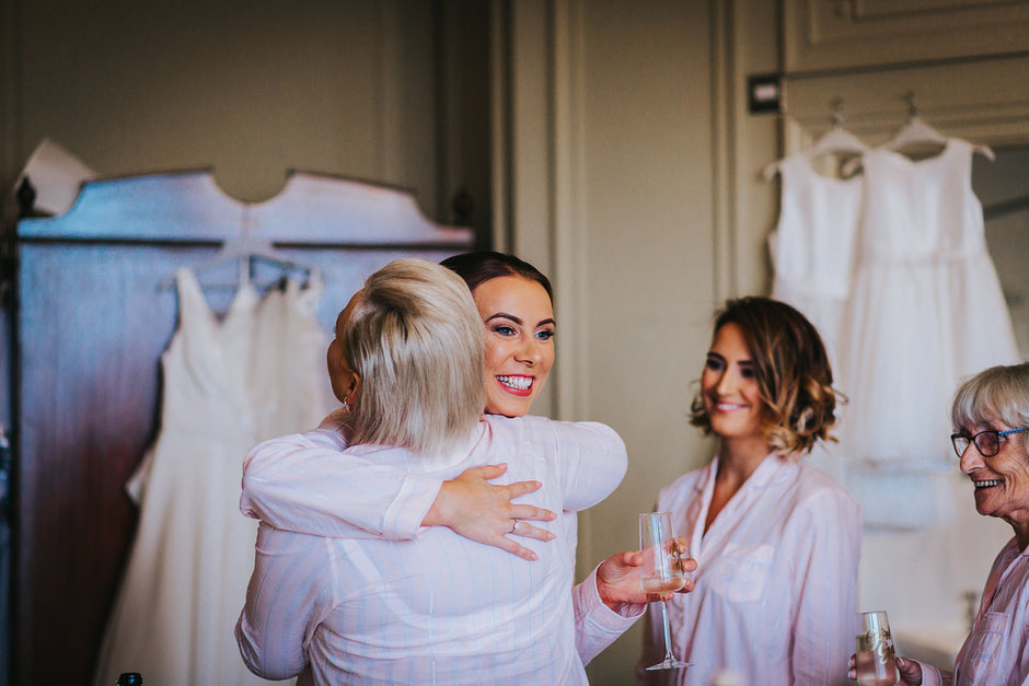 two ladies hugging at the merewood country house hotel on the morning of a wedding