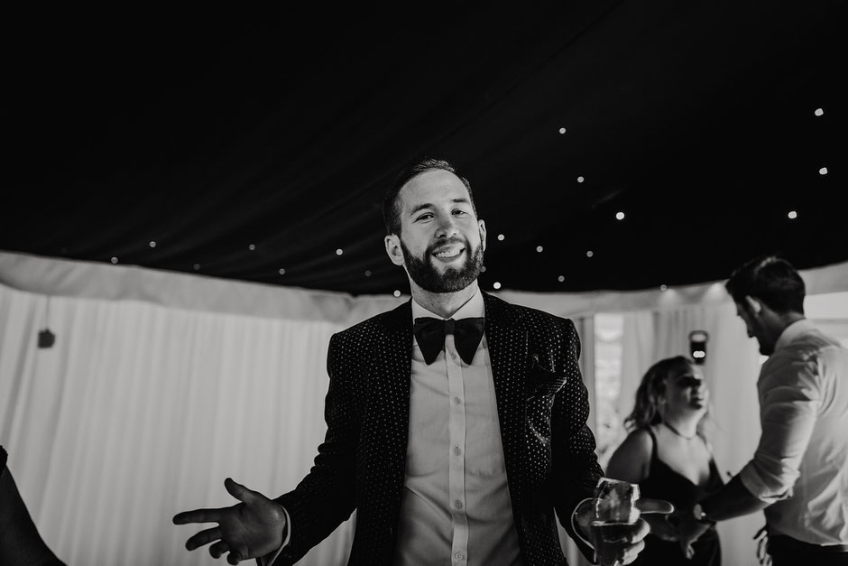 cool guy in a bow tie on the dancfloor at a soughton hall wedding