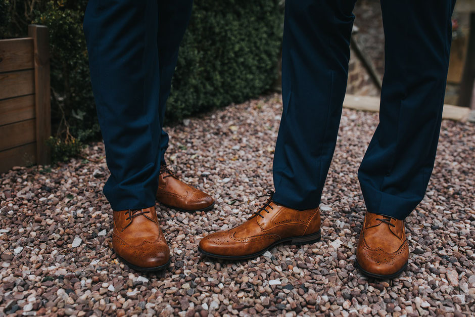 Detail shot of some brown shoes on gravel at soughton hall