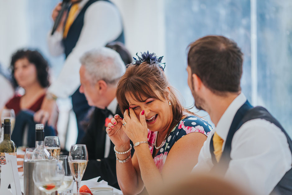 mother of the groom wiping tears from her eyes during speeches at soughton hall
