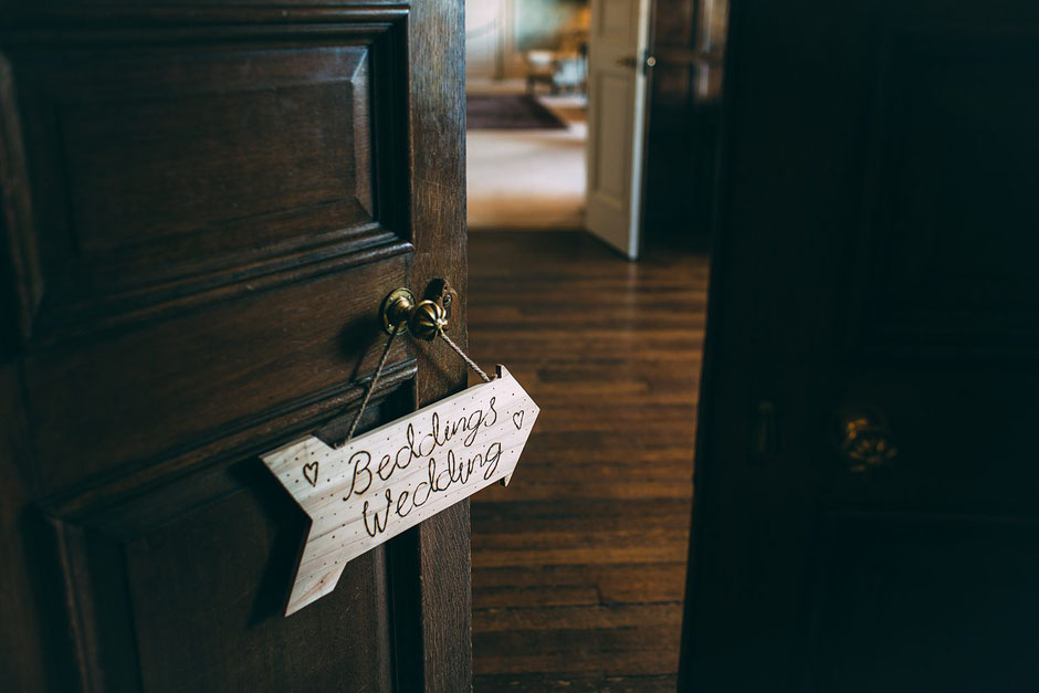 wooden sign made by the bride saying beddings wedding