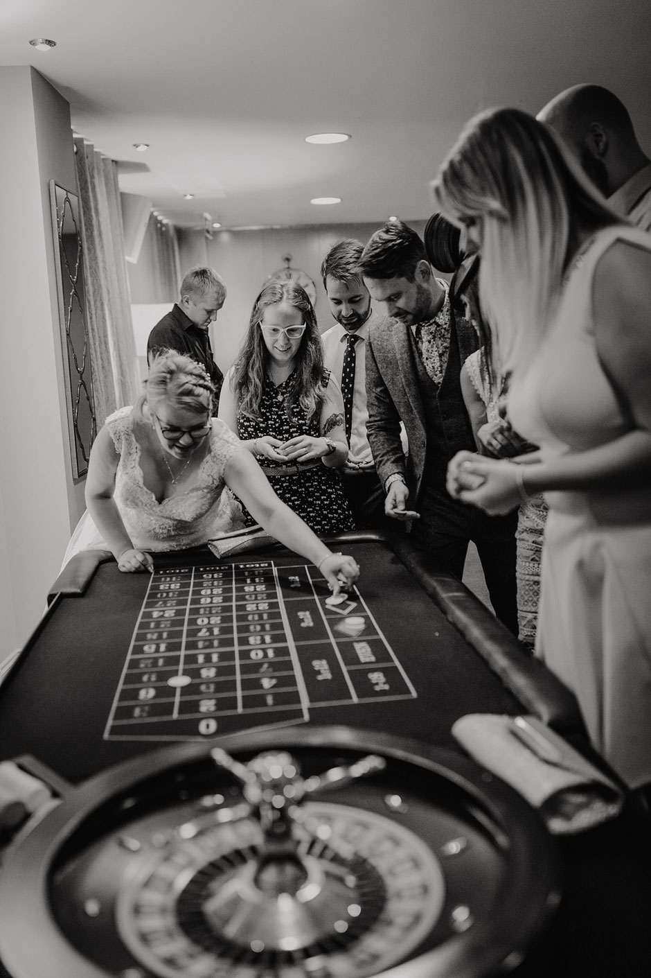 wedding guests surrounding a poker table at ribby hall