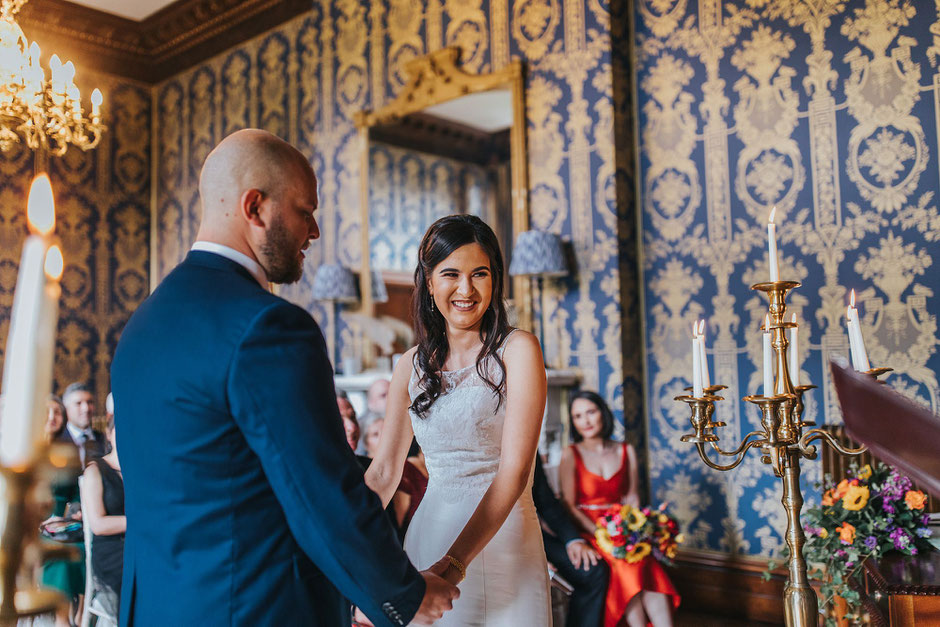 A bride looking happy at the registrar during the wedding ceremony