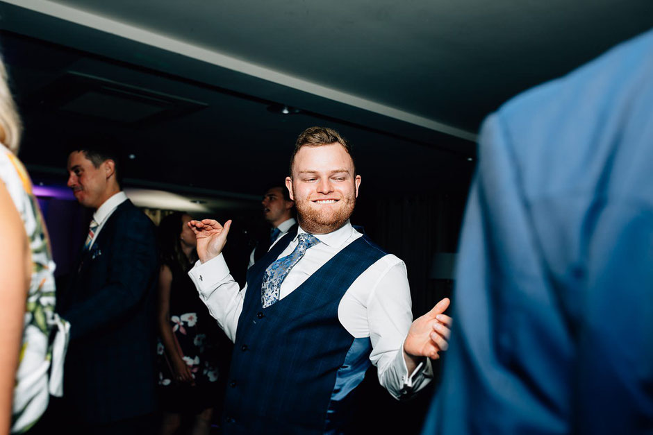 a male wedding guest dancing