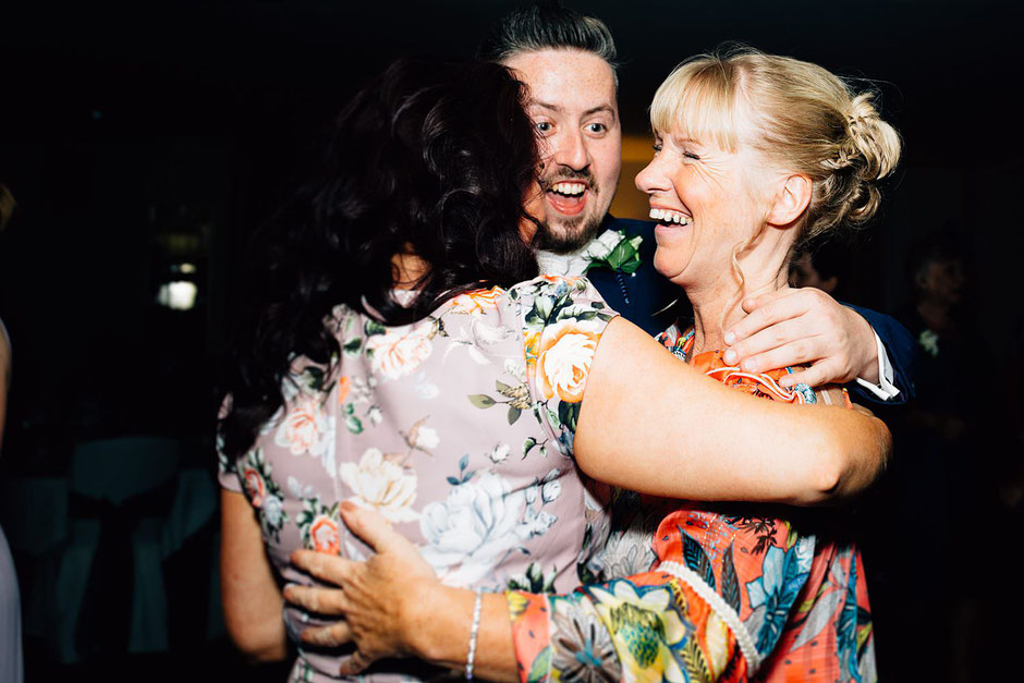 three people hugging