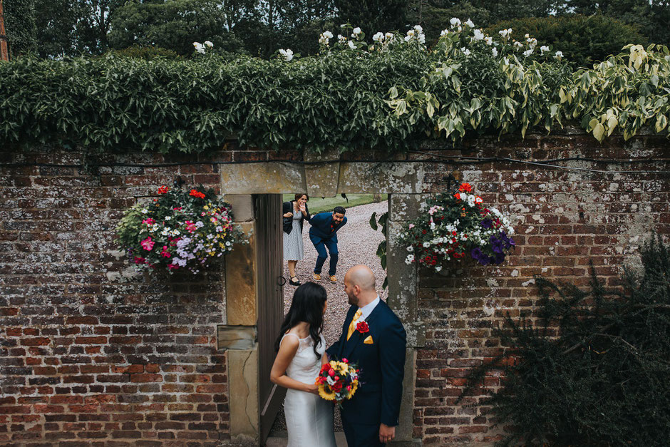 A couple photobombing bride and groom portraits