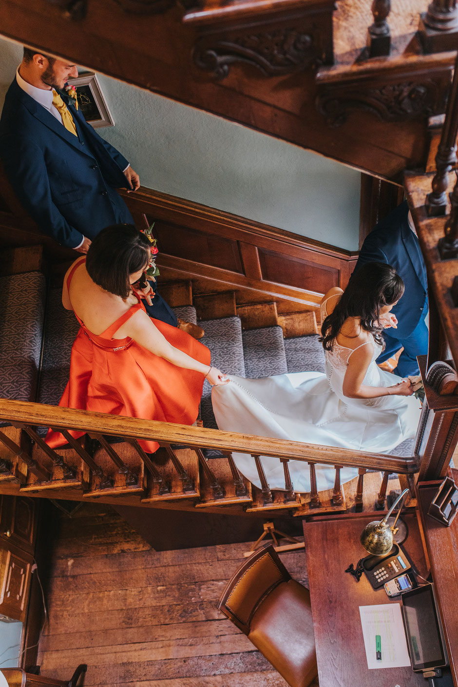 Bridal party walking down the stairs at soghton Hall