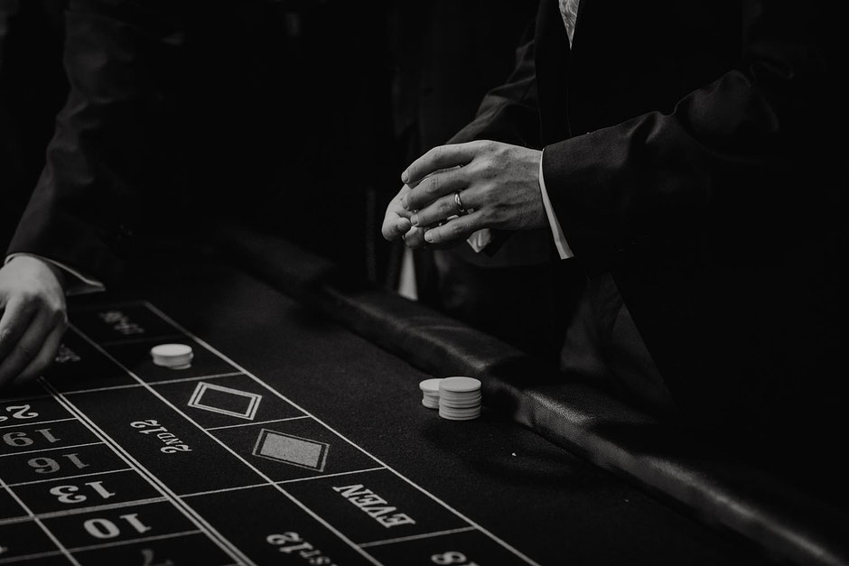 black and white photograph of a grooms hand as he plays poker