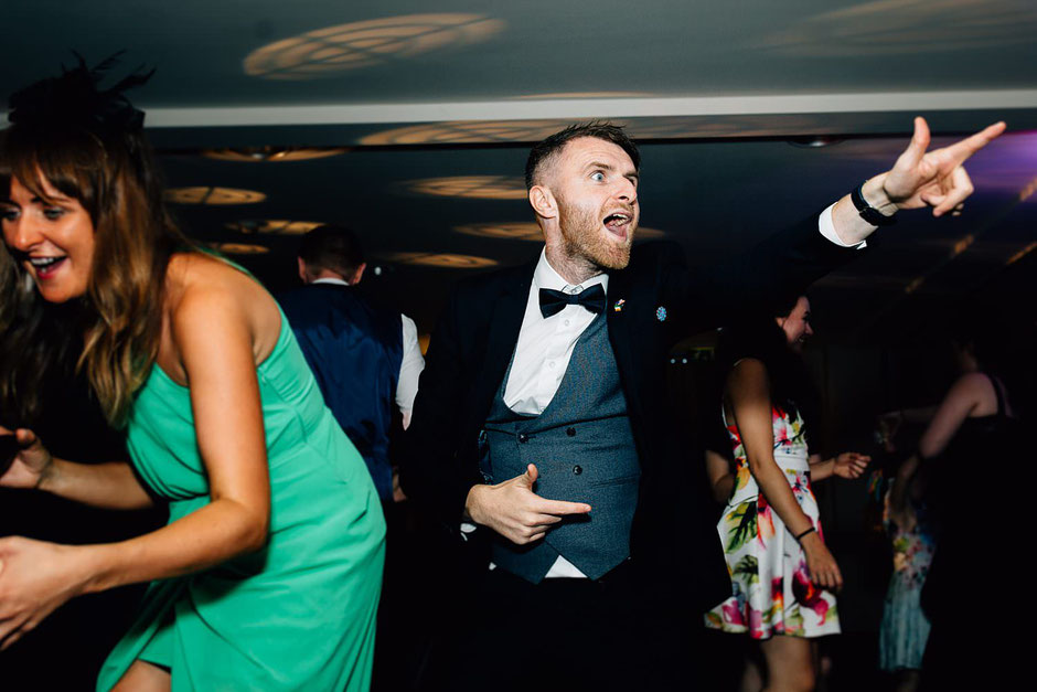 a man dressed in a bow tie dancing