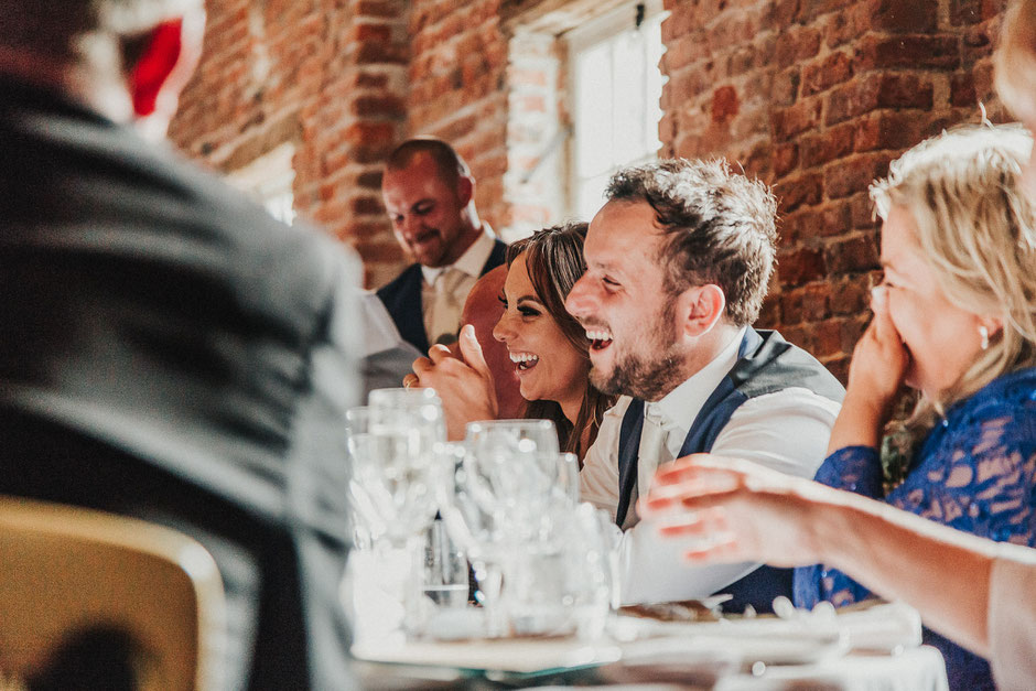 bride and groom laughing during speeches at meols hall