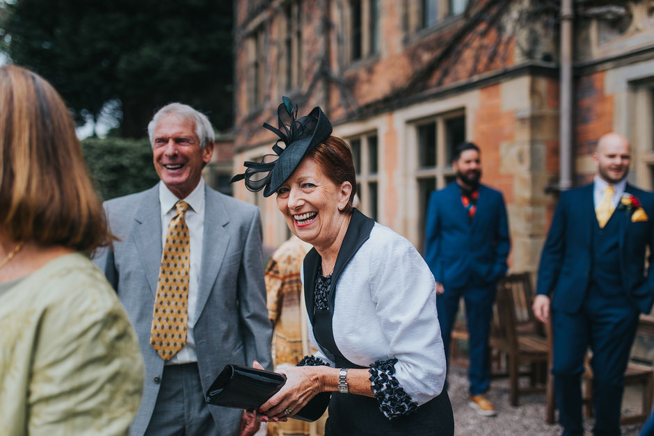 candid moment of a lady laughing during a wedding at soughton hall
