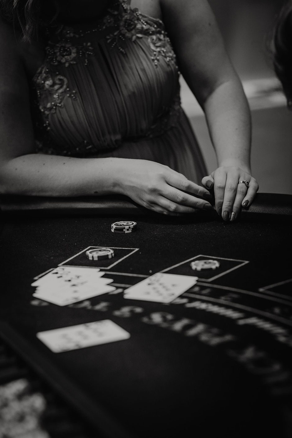 close up black and white photograph of a poker table
