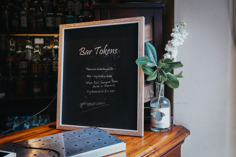 a chalk board with details of how guests can use their free drinks tokens
