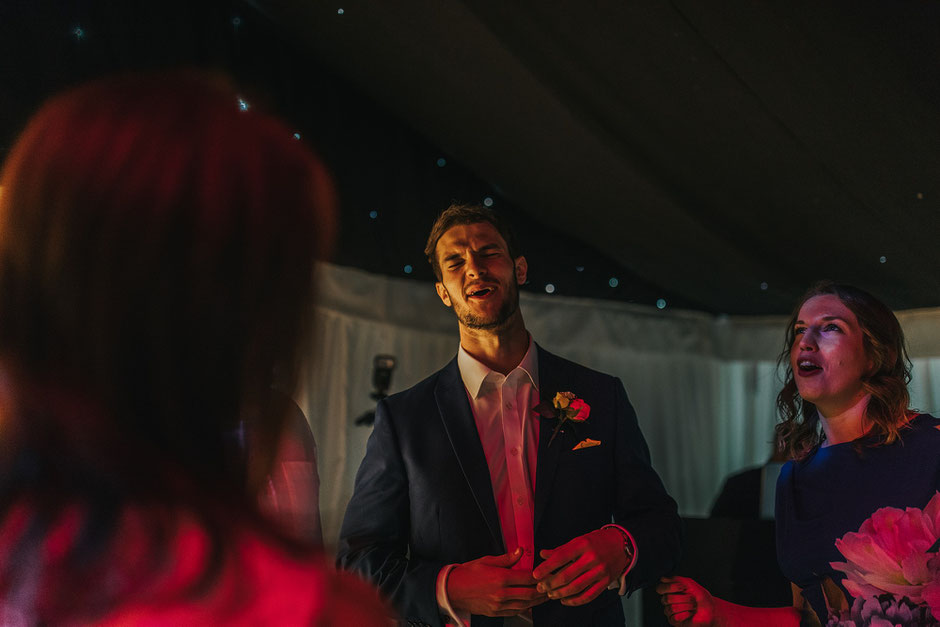 best man at a wedding singing and enjoying himself!