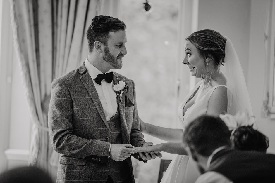 Bride and groom during the ring exchange part of their wedding ceremony
