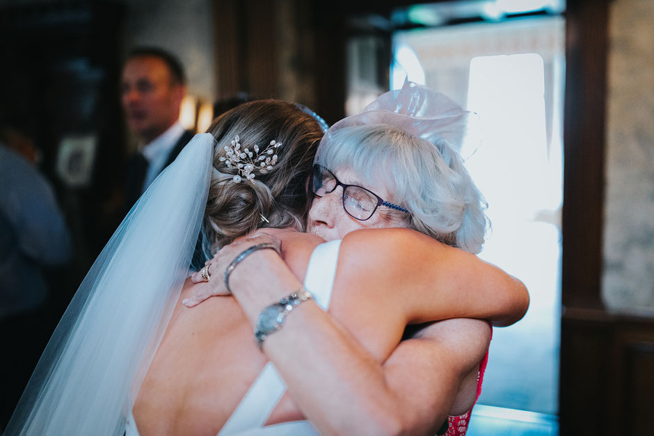 a bride and her grandmother hugging