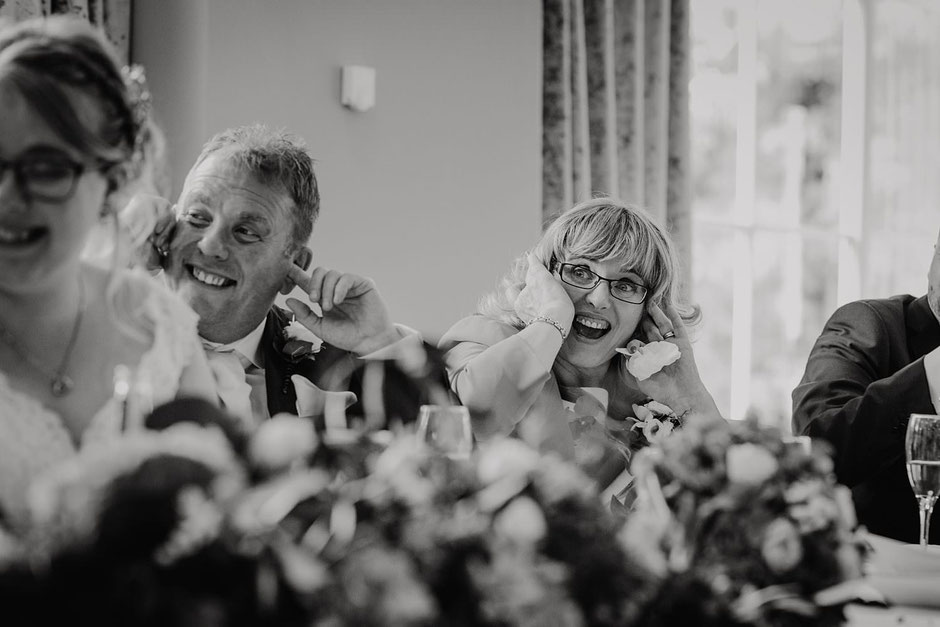 black and white photograph of a Mum & Dad during wedding speeches