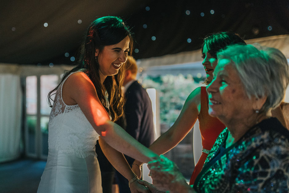 bride dancing with her grandma at her wedding with a huge smile on her face