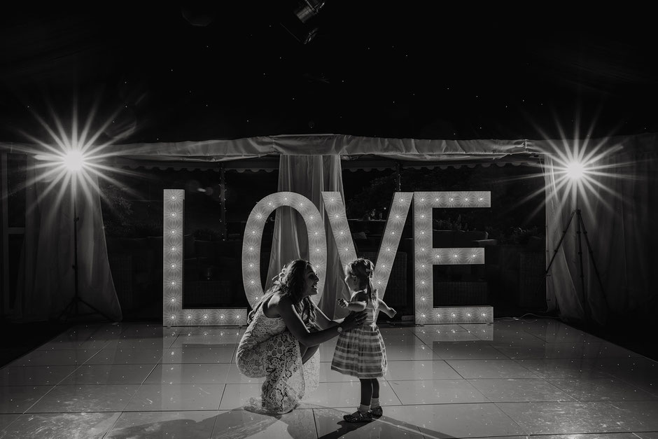 black and white photograph of a dance floor with a lady and little girl