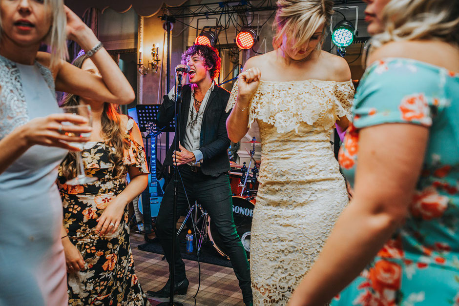 Warning Tones front man singing during the evening wedding reception
