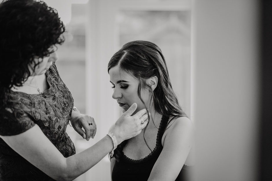 Black and white photograph of a moment between bride and her mother