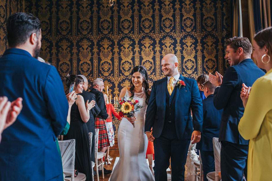bride and groom walking up the aisle after they are married at Soughton Hall