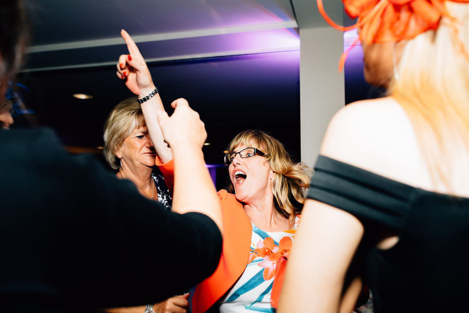 a woman dressed in orange dancing