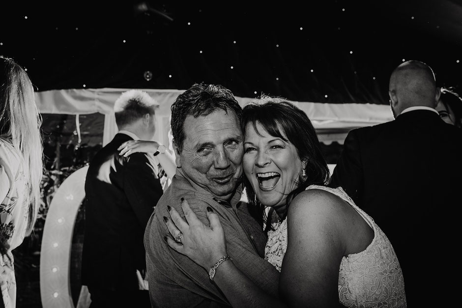 blanck and white photograph of two people having fun on the dancing floor