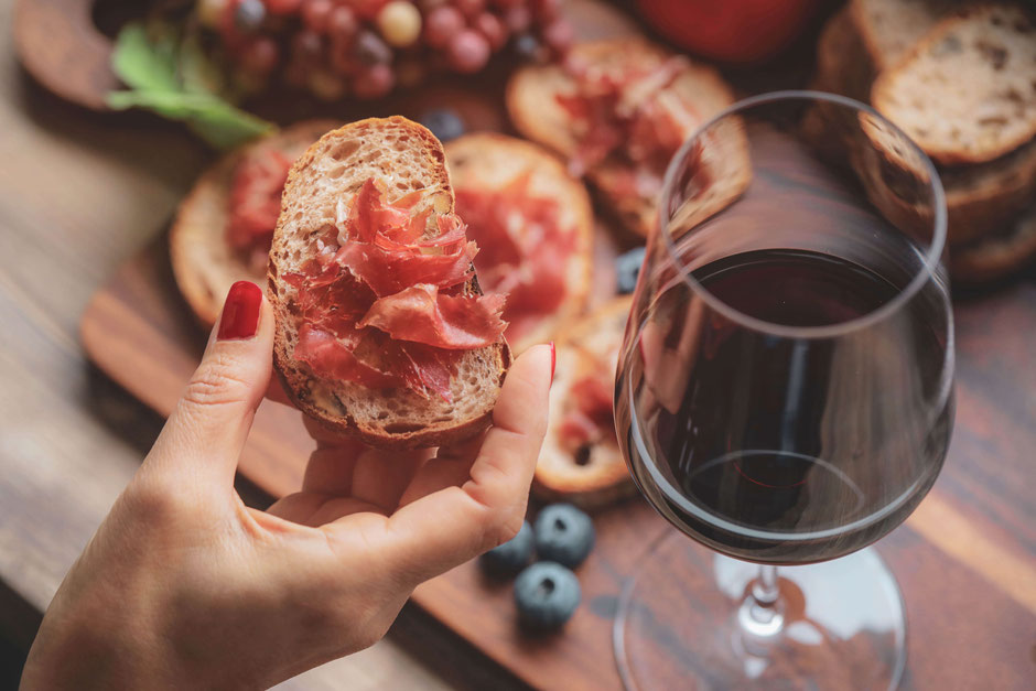 Bruschetta with smoked ham with a glass of red wine. Enjoy the good life during a holiday at Vecchi Maestri B&B, adults only accommodation in Le Marche, Italy.