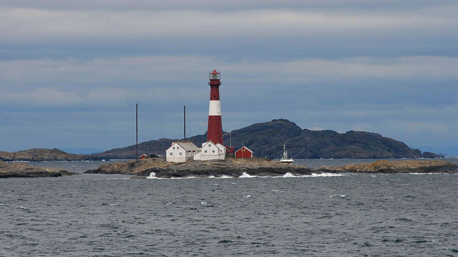 Færder ligthhouse, visible from 19M, seen from E, conspicuous 46m red and white tower marking W side of entry to Oslo Fjord, on the middle of the three low, narrow rocky N-S islands (Lille Færder, Færder, Tritsteinen)