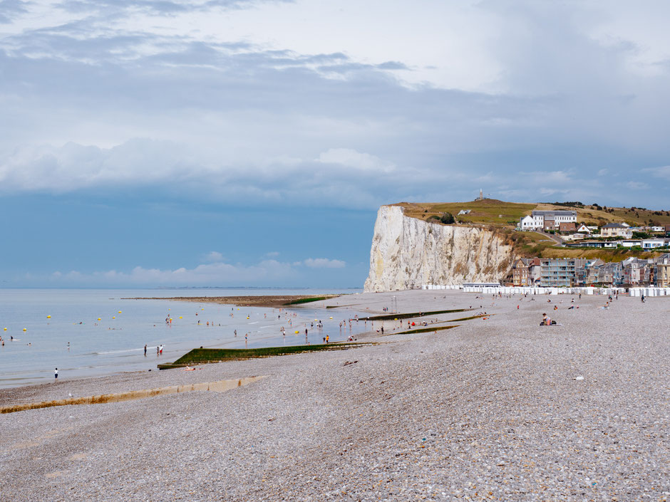 Pebble beach and cliffs on the background