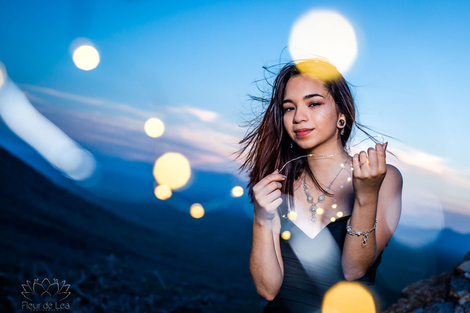 senior girl at sunset mountain session holding fairy lights. Fleur de Lea Photography