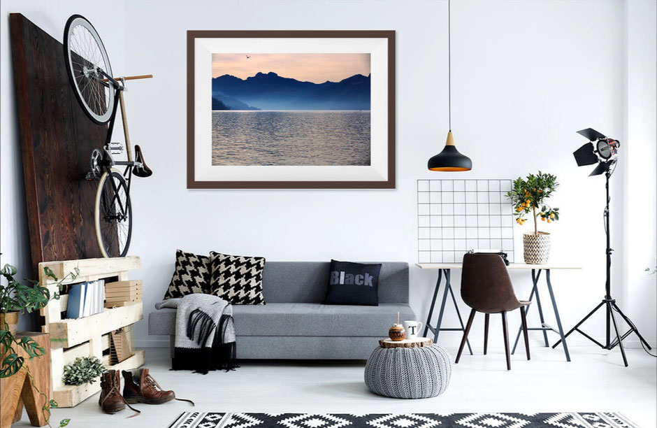 Photo of a room with a fine art print of Lake Como, blue mountains and a bird flying on the horizon
