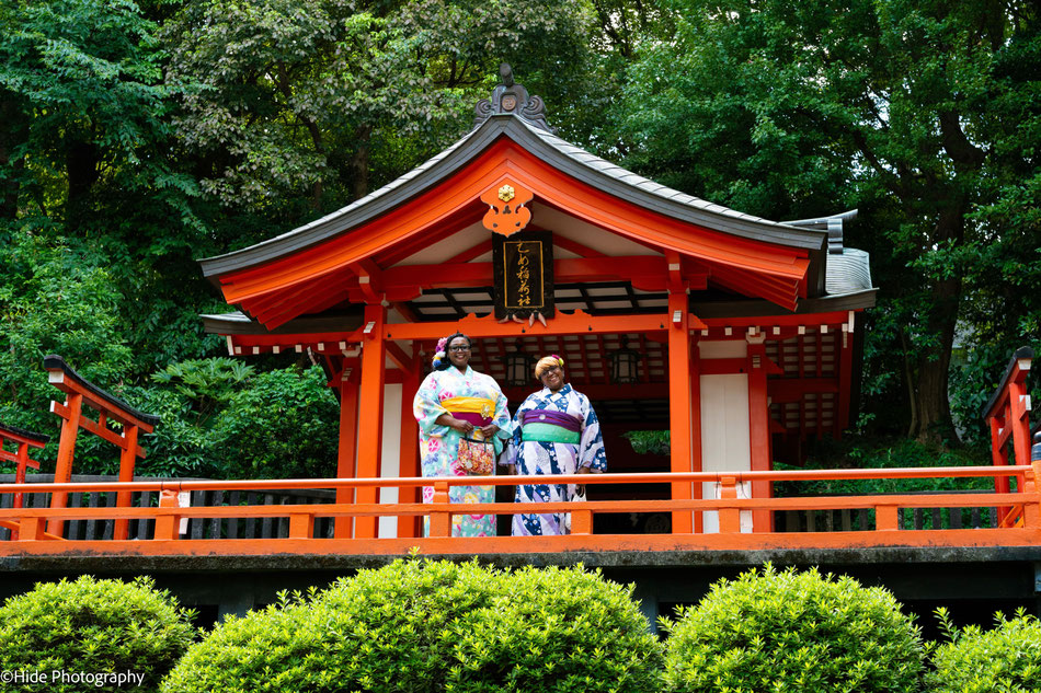 Women wearing kimono in front of a shrine building at Nezu Shrine in Tokyo